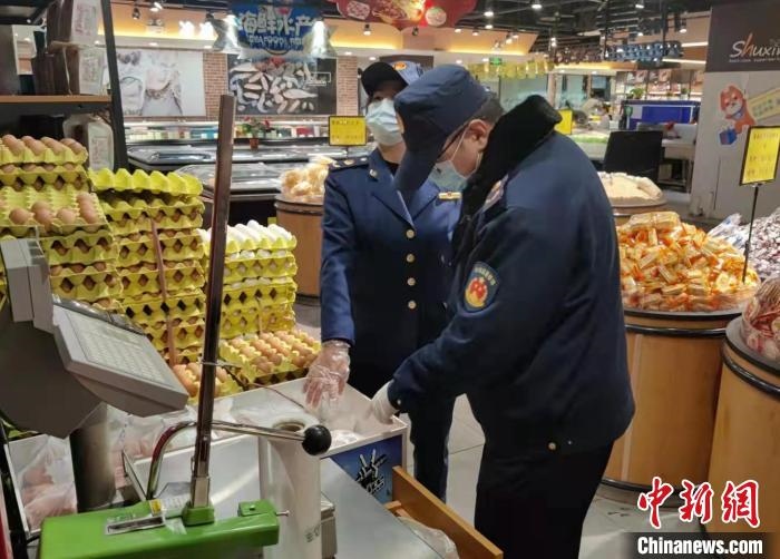 圖為疫情期間，甘肅嘉峪關市場監(jiān)管局工作人員檢查蔬菜市場。　 柴佳楠 　攝