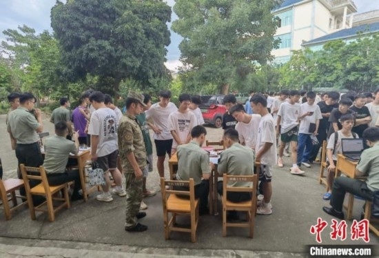 專武干部在發(fā)放兵役登記證。韋碩 攝