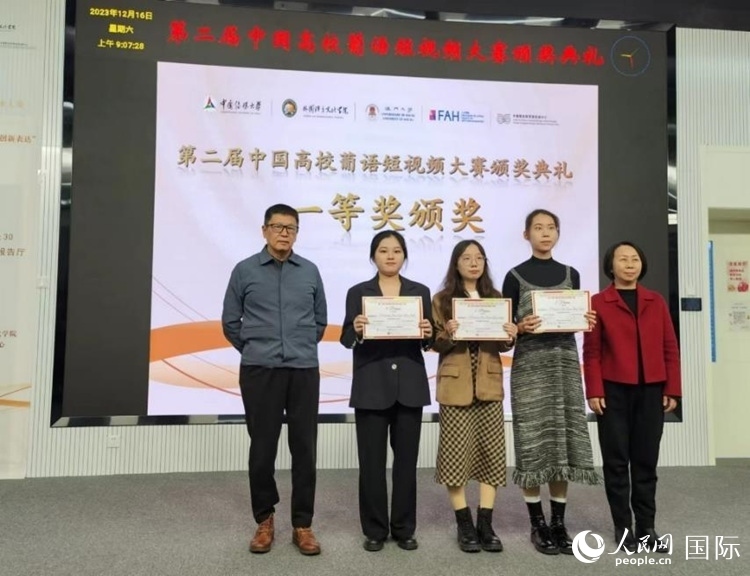 澳門(mén)大學(xué)中葡雙語(yǔ)教學(xué)暨培訓(xùn)中心主任姚京明（左一）和中國(guó)傳媒大學(xué)外國(guó)語(yǔ)言文化學(xué)院院長(zhǎng)文春英（右一）為一等獎(jiǎng)獲得者頒獎(jiǎng)。人民網(wǎng)記者 魯揚(yáng)攝
