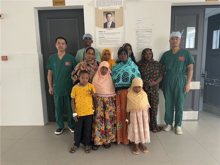 李廣（右一）和王林醫(yī)生與部分患者合影。中國(guó)援桑醫(yī)療隊(duì)供圖