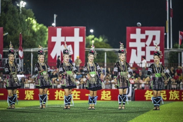 2024年9月28日，榕江縣侗族大歌隊(duì)的演員們?cè)凇按宄弊闱驁?chǎng)上表演。當(dāng)日，“發(fā)現(xiàn)中國(guó)之美·相約貴州村超”國(guó)際友誼賽在貴州省黔東南苗族侗族自治州榕江縣的“村超”足球場(chǎng)舉行。新華社記者 陶亮 攝